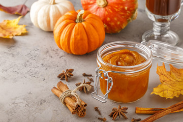 Pumpkin butter on concrete background.