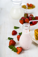 Smoothie and waffles with strawberries