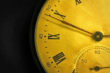 Tarnished clock face of old soviet pocket watch close up on dark background