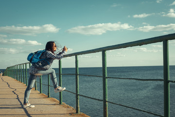 Attractive hipster girl with back pack enjoying her holidays.