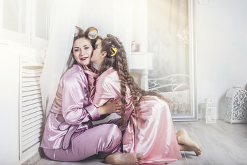 Mother and daughter alone at home beautiful, fashionable and fun