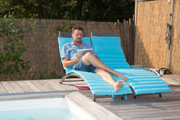 Man using laptop in the pool - work anywhere