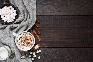 Wooden background with cap of cacao and marshmallow