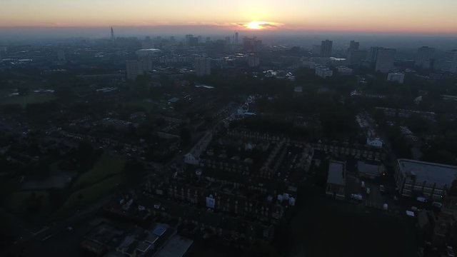 Aerial view of Birmingham city centre at sunrise. Flying backwards from Edgbaston.