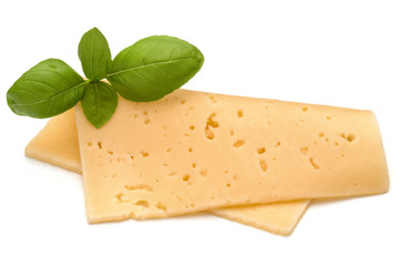 cheese slice and basil herb leaves isolated on white background