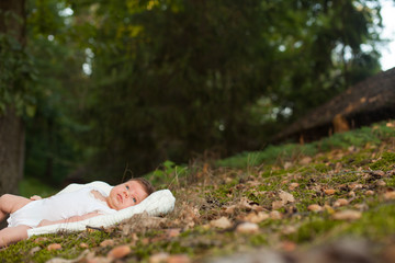 Baby lying on the blanket on the grass