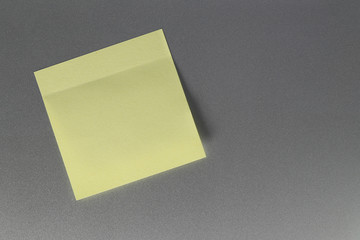Empty yellow paper sheet on refrigerator door for design.