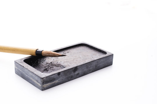 Chinese brushes and ink stone writing instrument on white papers