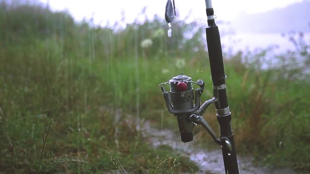 Fishing rod in the heavy rain in the summer close-up.
