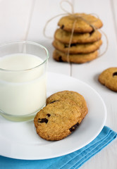 Homemade cookies with chocolate pieces and fresh milk.