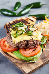 Gourmet burger with spicy jalapenos and spinach