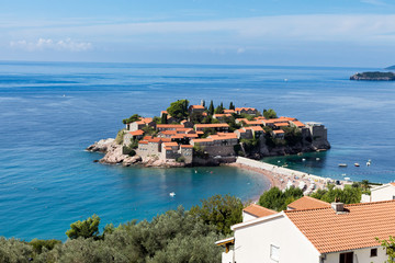 Fototapeta na wymiar View of the island of Sveti Stefan on a sunny day, the end of September