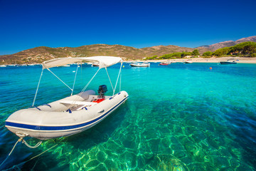 Motor boats with sandy beach near Sagone, Corsica, France