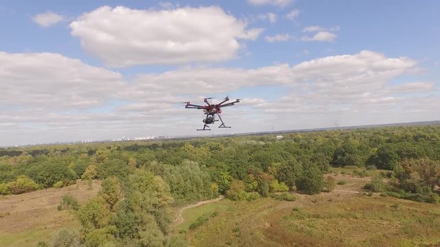 Drone copter UAV - aerial video shooting flying on eight propellers oktocopter. Video capture of professional oktocopter in the air with help of the other copter during the flight.
