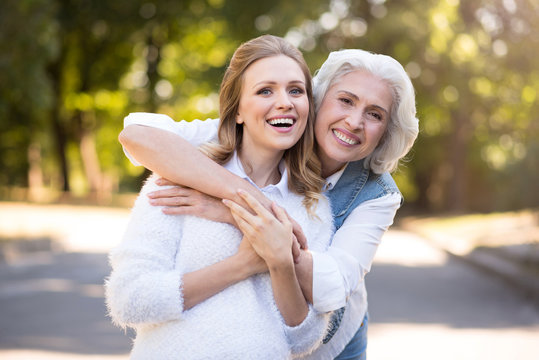 Two delighted happy women having a walk.