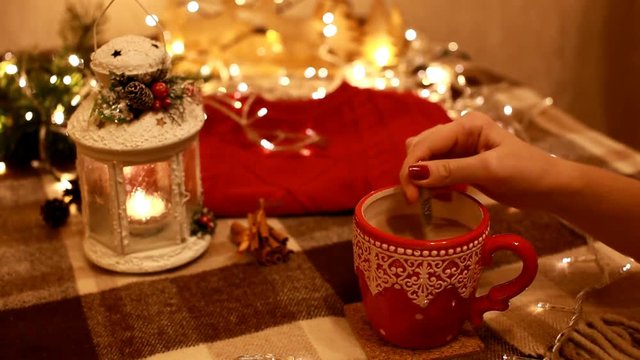 cup of hot cocoa with marshmallow with Christmas decorations at home, Christmas tree on background, cozy mood
