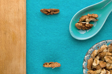 Walnuts. Top view of wooden Board and blue background. For kitchen and menu 