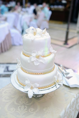 Beautiful wedding cake for bride and groom indoors. Colorful pie for celebration. Beauty of bridal interior for marriage