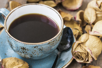 Cup of coffee and dry rose