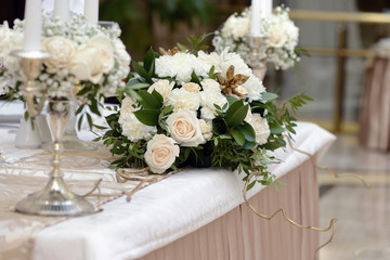 Beautiful wedding restaurant for marriage. White decor for bride and groom. Colorful decoration for celebration. Beauty bridal interior. Bouquet and flowers in hall