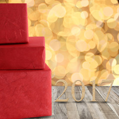 Red gift boxes and wood number of 2017 on a wooden floor and gol © meepoohyaphoto