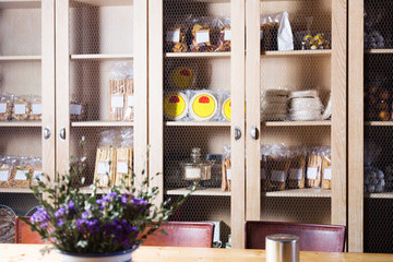 Interior of cafe with sweet stuff in cupboards