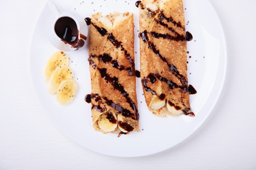 Pancakes with banana and chocolate topping.selective focus.