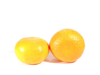 Close-up of two ripe oranges isolated on white background