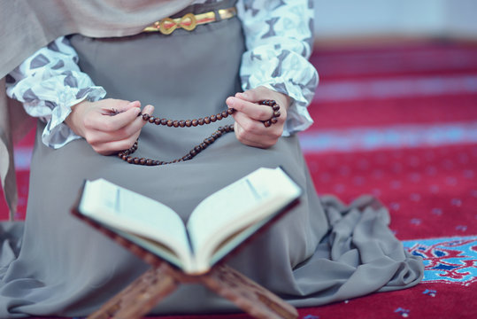 Young muslim woman praying in mosque