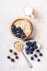 Fototapeta na wymiar Oatmeal,Granola with berries and milk,blueberries.Dry Breakfast.Healthy food or diet concept. top view. selective focus.