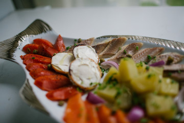 Tasty salted appetizers lie over a dish in the form of fish