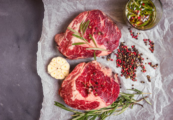 Raw meat steak on a baking paper ready to roasting