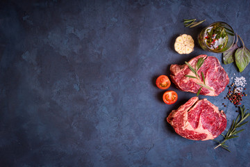 Obraz na płótnie Canvas Raw meat steak on rustic concrete background ready to roasting