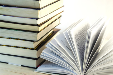 stack of books and opened book