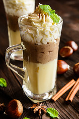 Vanilla pudding with chestnuts puree and whipped cream in a glass jar