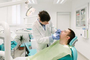 Dentist is working on his patient