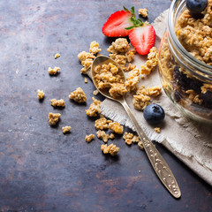 Homemade muesli granola in a jar on rusty black table