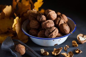 Walnuts in a bowl on a gray background