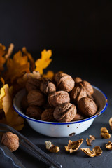 Walnuts in a bowl on a gray background