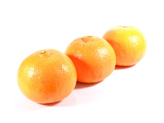 Three ripe oranges isolated on white background, close-up 