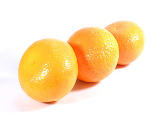 Close up of three ripe oranges isolated on white background 