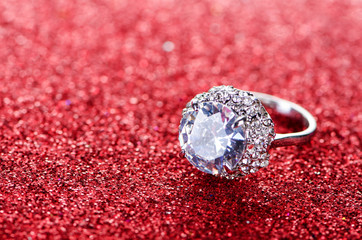 Jewellery concept with ring on shiny background