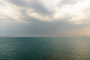 Landscape with water sea and a storm at the horizon