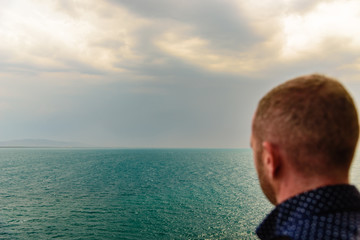 Fototapeta premium A man watching the sea and the horizon