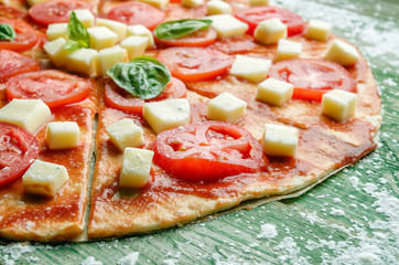 Slice of raw pizza with mozzarella in flour