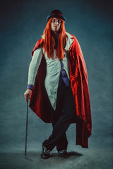 Portrait of ironical circus actor in tuxedo.