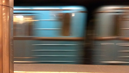 Rapid metro train moving across empty station