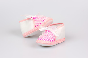 Cute pink baby girl shoes close up