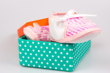 Cute pink baby girl shoes in a box
