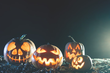Halloween pumpkins at wood background.